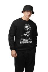 Person wearing a black sweatshirt with a graphic design and text on a brown background