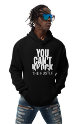 Person wearing a black hoodie with text, sunglasses, and ripped jeans on a white background