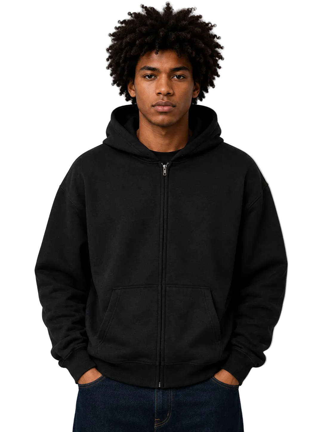A man with an afro hairstyle wearing a black full-zip hoodie and dark blue jeans, standing against a neutral gray studio background.