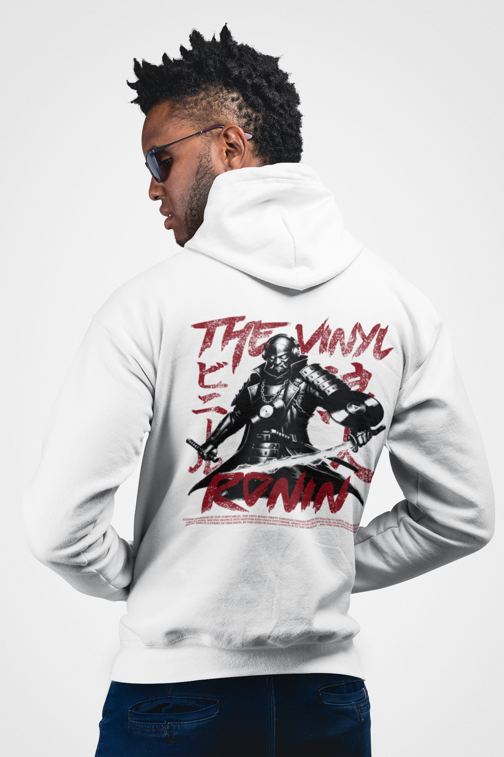 Man wearing a white hoodie with a graphic design on the back, standing against a white background.