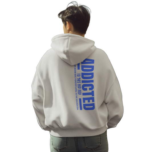Person wearing a hoodie with 'ADDICTED' text on the back in an urban setting