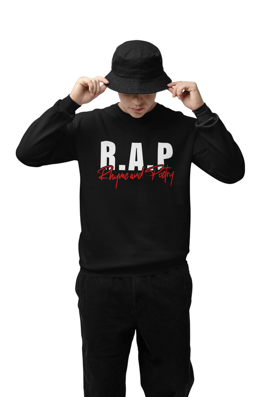 Person wearing a black 'R.A.P' sweatshirt and black hat on a green background