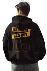 Person wearing a black hoodie with 'Original Bad Boy DJ' text on the back in an urban setting.